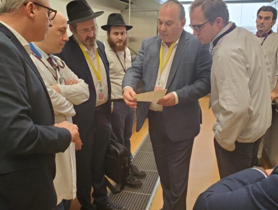 Rabbi Marc Schneier, holding paper, and Rabbi Mendy Chitrik, third from left, worked together on the initiative. (Courtesy of Schneier)